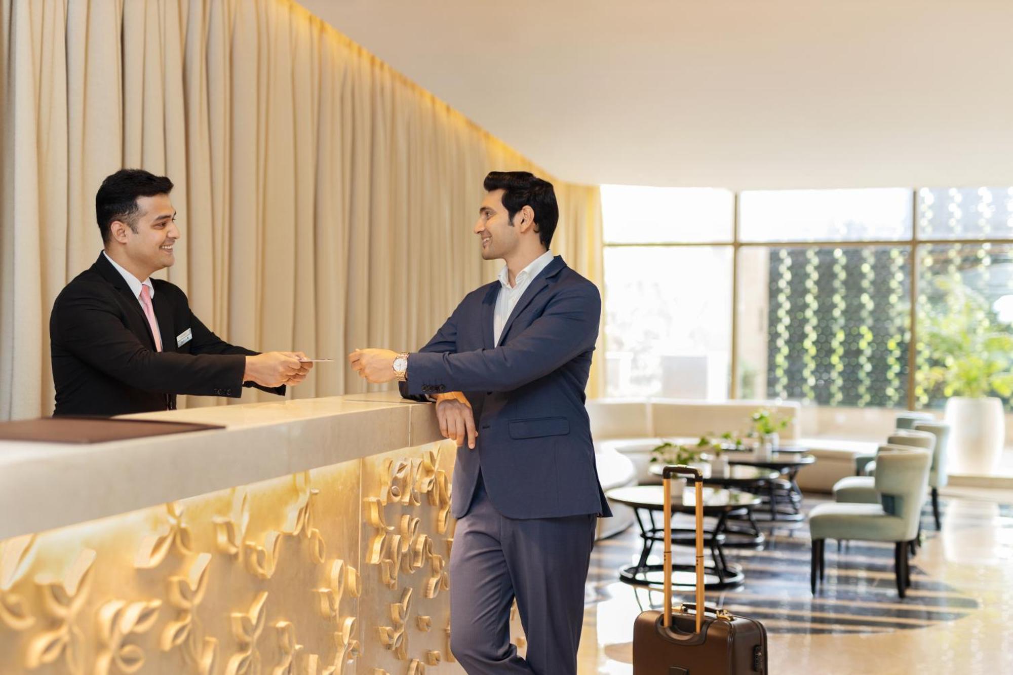 Radisson Blu Hotel New Delhi Dwarka Экстерьер фото A guest checking in at a hotel